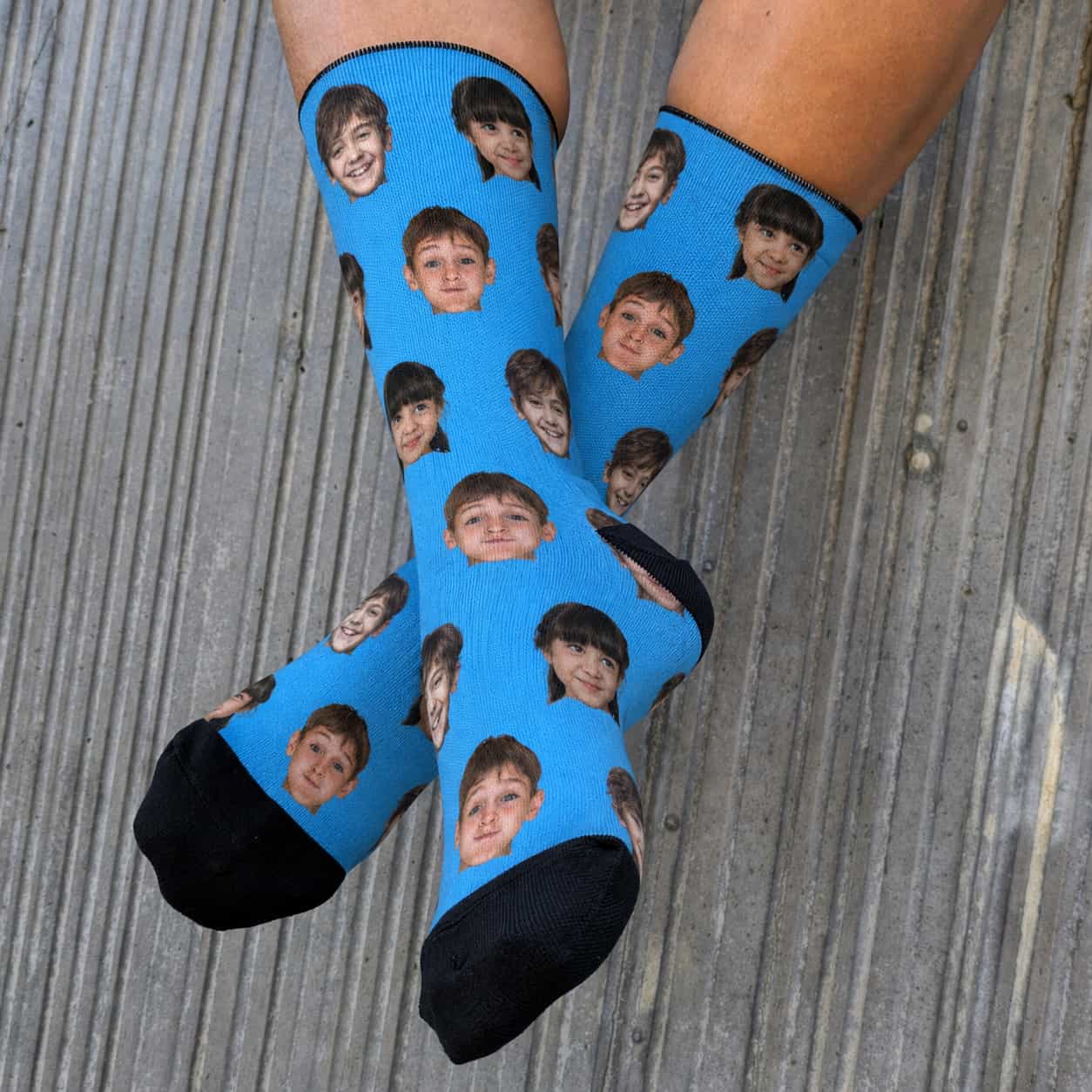 Custom face socks with three kids' faces on a blue background