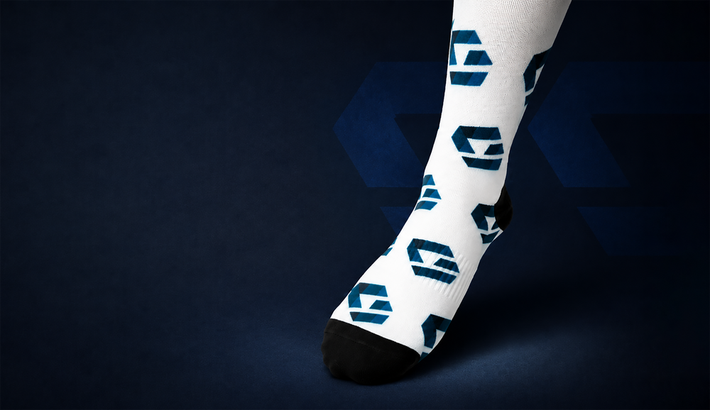 White custom logo sock with an all-over brand pattern on a dark blue background