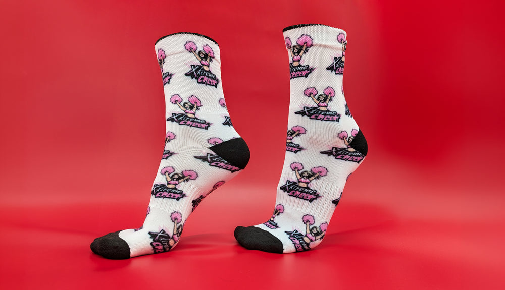 Custom spirit socks with a pink cheerleader pom-pom design on a red background