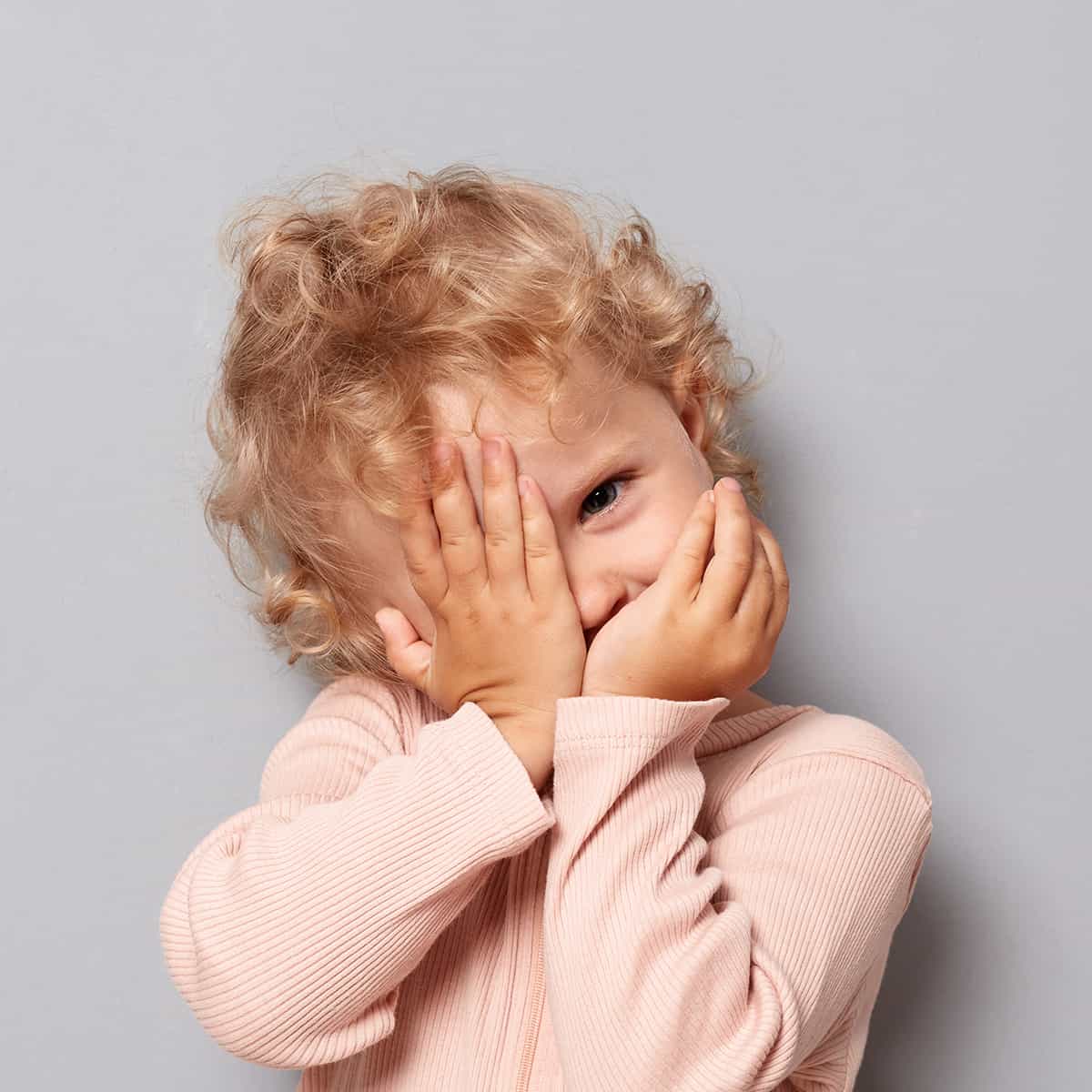 Toddler with hands covering the face — a photo that won't work