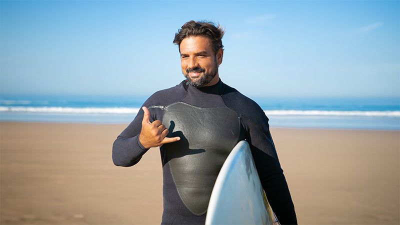 A casual photo of a smiling man at the beach