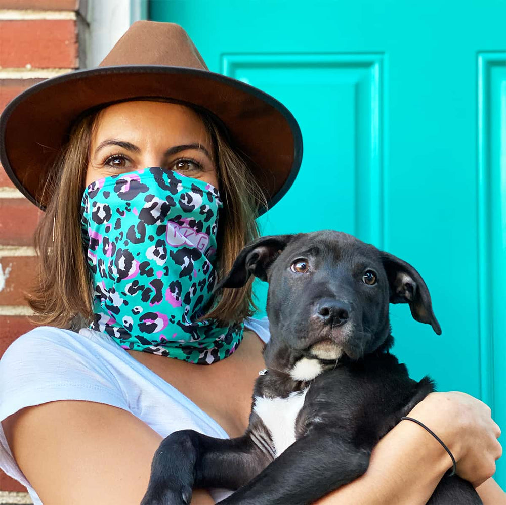 Girl with a dog wearing a custom neck gaiter