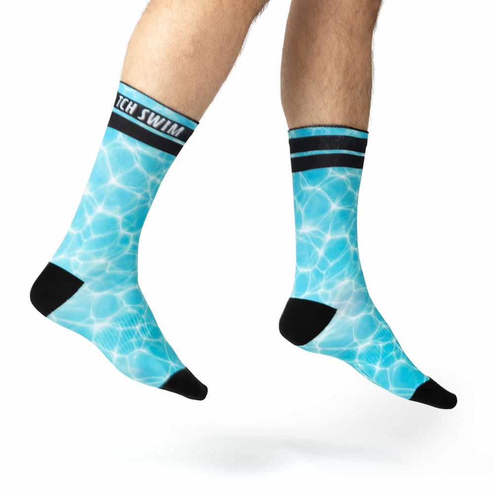 Blue socks in the pattern of a pools surface with swim team name