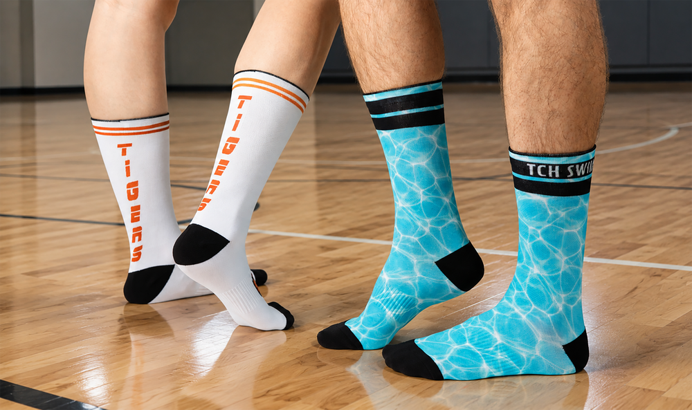 Two players on a basketball court wearing custom team socks with orange Tigers lettering